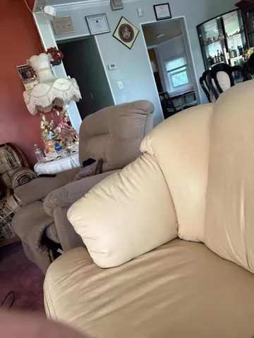a view of living room with furniture and wooden floor