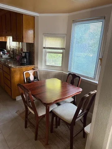 a view of a dining room with furniture and a window