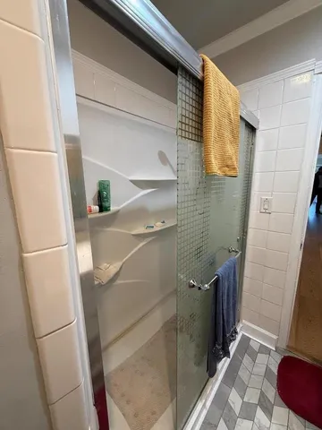 a bathroom with a sink and a refrigerator