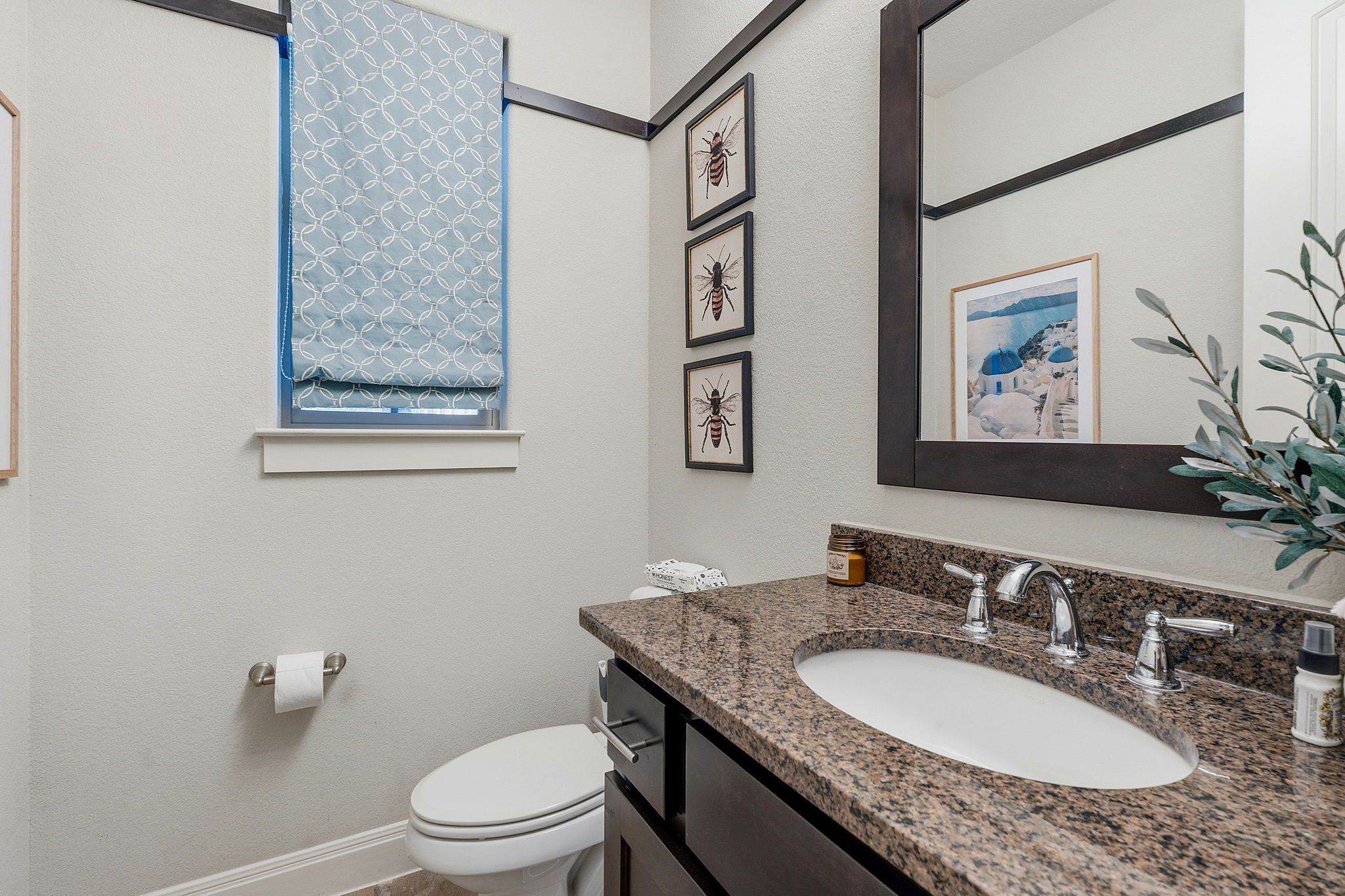 15317 Falconhead Grove Loop Austin, TX 78738 - Photo 24 of 36 Powder room featuring a dark wood vanity with a granite countertop, undermount sink, and chrome faucet
