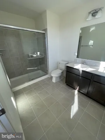 a bathroom with a sink mirror and a shower