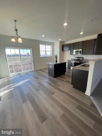 a view of kitchen with furniture wooden floor and window