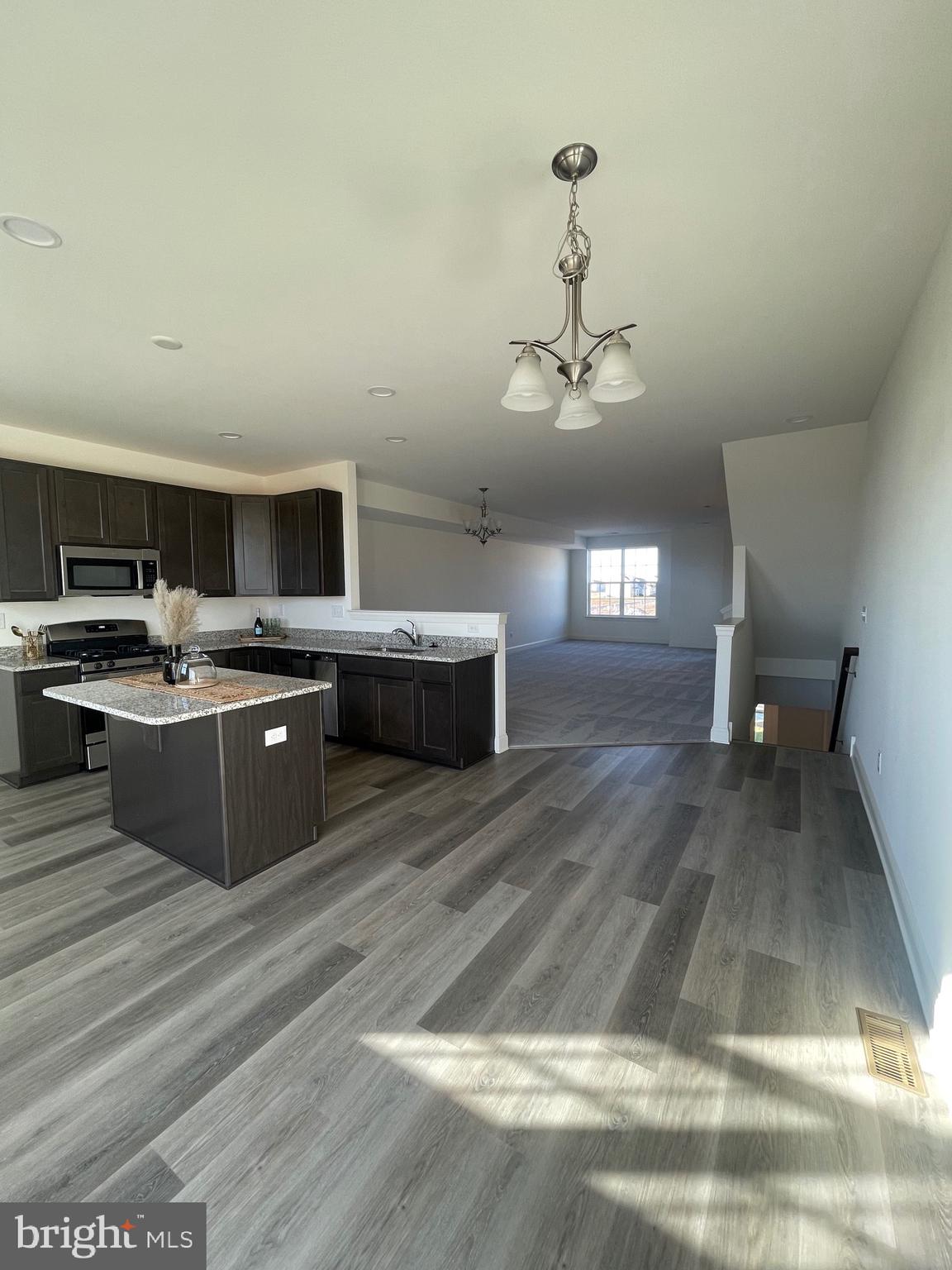 444 Rederick Lane Middletown, DE 19709 - Photo 5 of 16 a kitchen with stainless steel appliances granite countertop a stove a sink dishwasher and a refrigerator with wooden floor