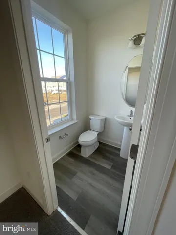 a bathroom with a toilet and a mirror