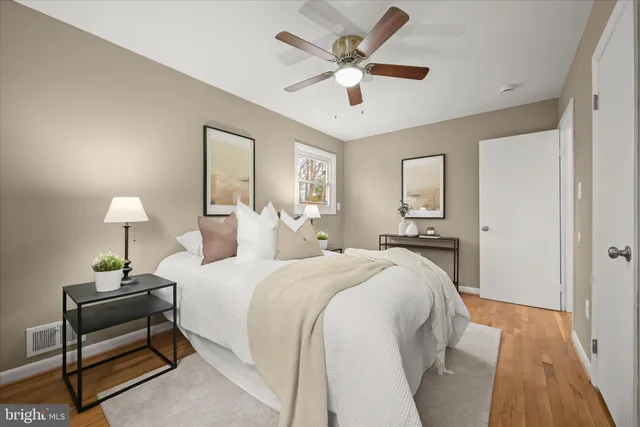 a spacious bedroom with a bed and a lamp