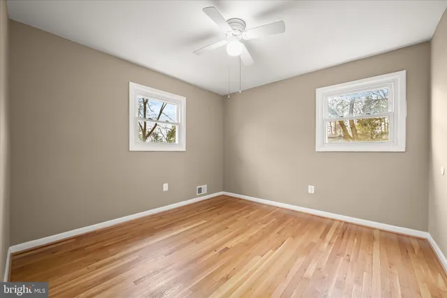 a view of room with window and wooden floor