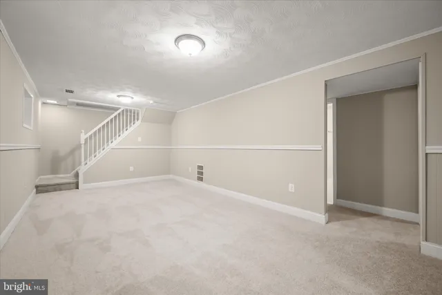 an empty room with white walls and empty shelves