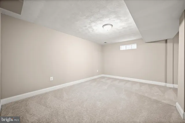 an empty room with a empty space and windows