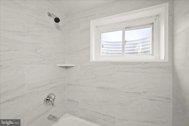 a bathroom with a bathtub and a window