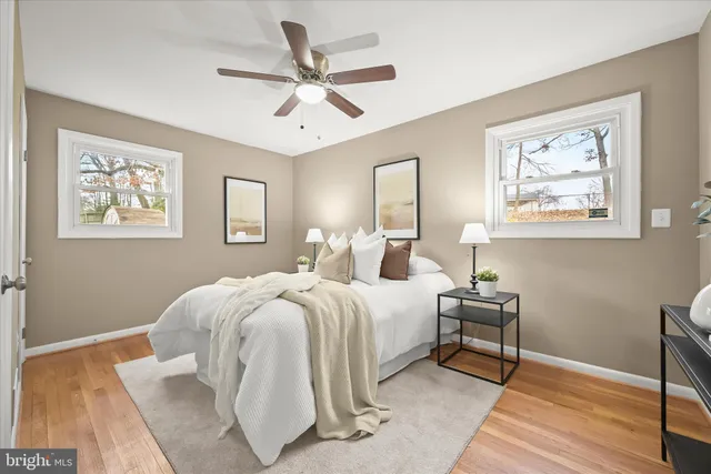 a spacious bedroom with a bed and a chandelier