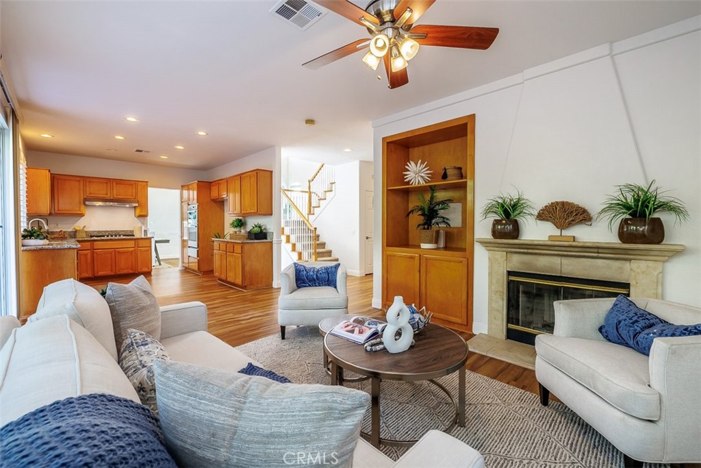 41 Castletree Rancho Santa Margarita, CA 92688 - Photo 15 of 68 a living room with furniture kitchen view and a fireplace
