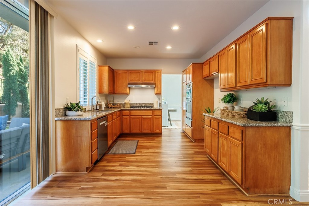41 Castletree Rancho Santa Margarita, CA 92688 - Photo 20 of 68 a kitchen with stainless steel appliances granite countertop a stove a sink and a refrigerator