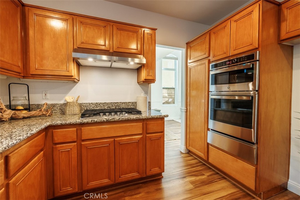 41 Castletree Rancho Santa Margarita, CA 92688 - Photo 22 of 68 a kitchen with stainless steel appliances granite countertop a stove and a refrigerator