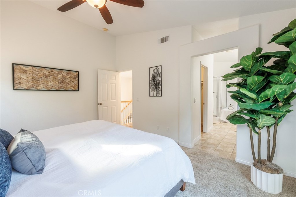 41 Castletree Rancho Santa Margarita, CA 92688 - Photo 38 of 68 a bedroom with a bed and a potted plant