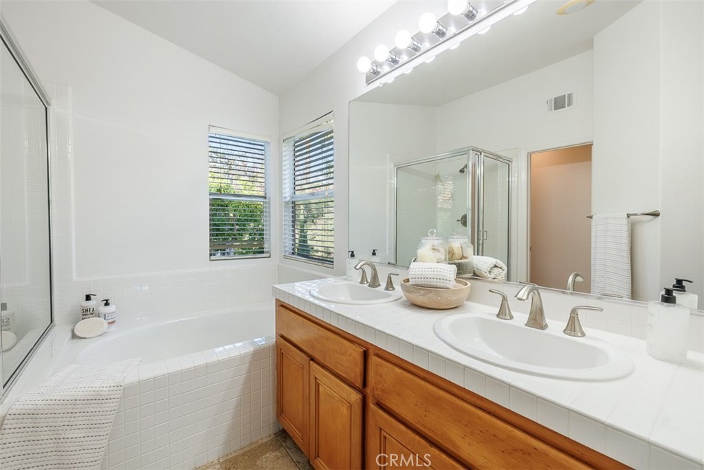 41 Castletree Rancho Santa Margarita, CA 92688 - Photo 41 of 68 a bathroom with a tub double sink and mirror