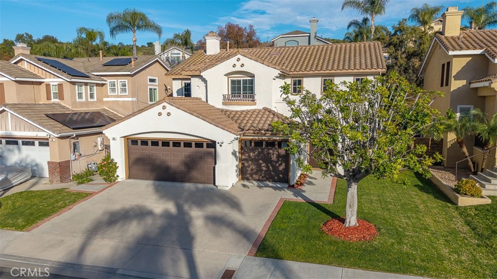 41 Castletree Rancho Santa Margarita, CA 92688 - Photo 58 of 68 a front view of a house with a yard and garage