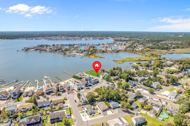 an aerial view of a house with a lake view