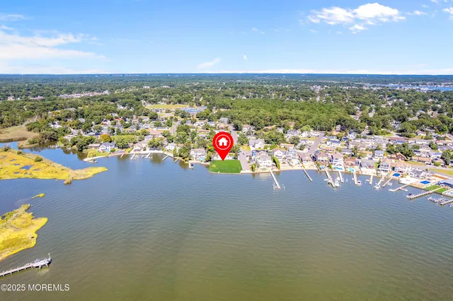 an aerial view of a house with a lake view