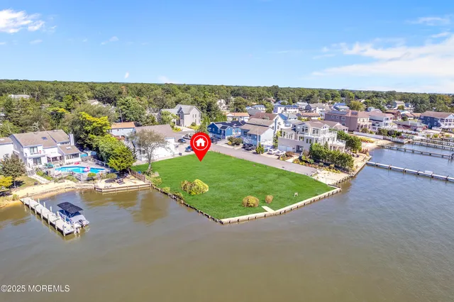 an aerial view of a house with a lake view