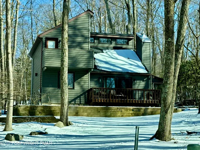 a view of a wooden door of the house