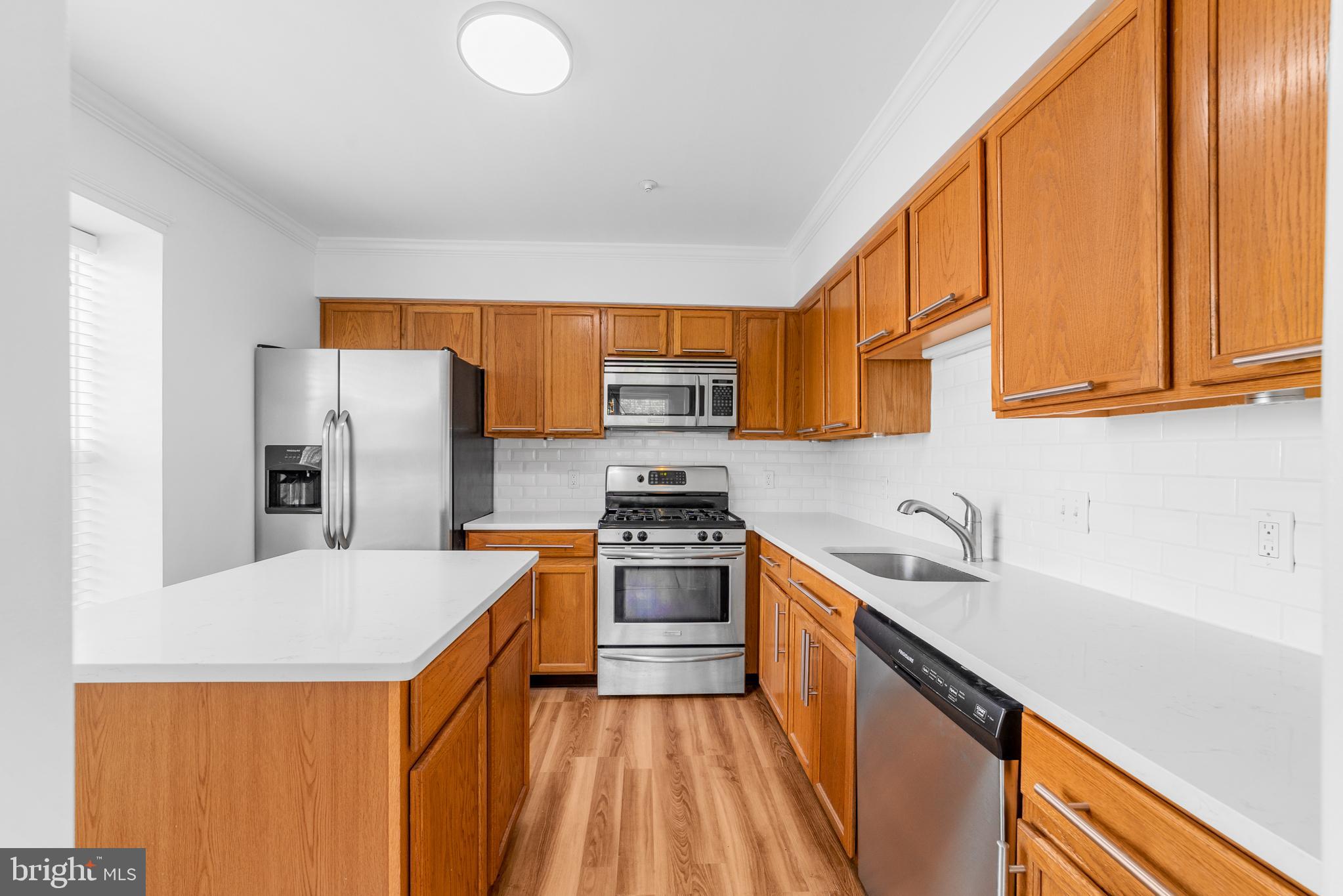 1010 Crestmont Drive Mantua, NJ 08051 - Photo 11 of 25 a kitchen with stainless steel appliances granite countertop a sink stove and refrigerator