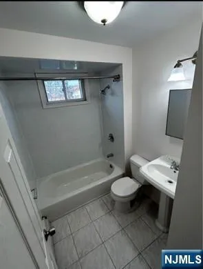 a bathroom with a toilet a sink and bathtub