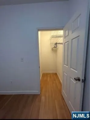 wooden floor in a bathroom next to a window