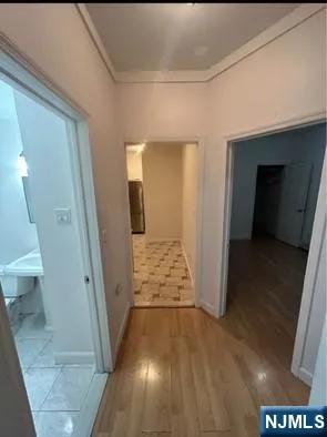 a view of a hallway with wooden floor and stairs