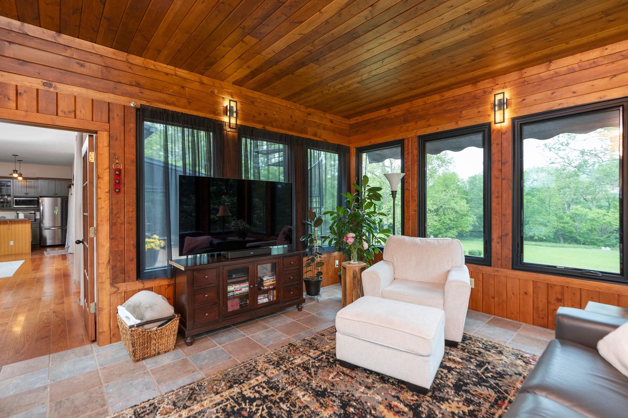 216 Lee Roy Road Grottoes, VA 24441 - Photo 22 of 64 a living room with furniture a flat screen tv and a floor to ceiling window