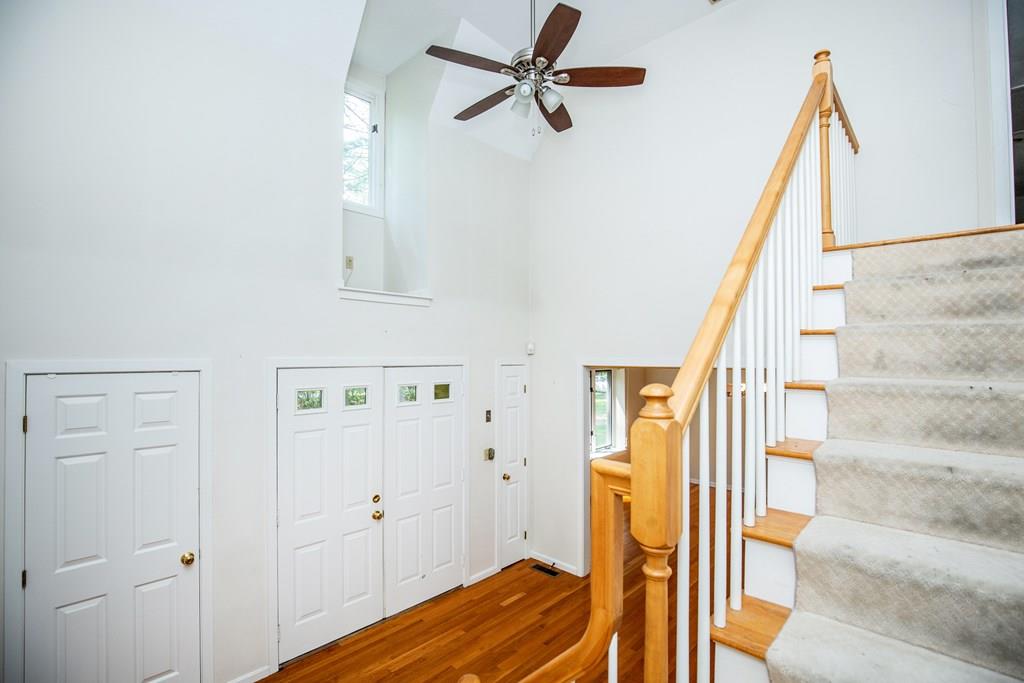 15 Arrowhead Farm Road Boxford, MA 01921 - Photo 2 of 25 a view of a hallway with wooden floor and staircase