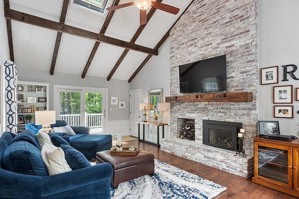 18 Higate Road Chelmsford, MA 01824 - Photo 16 of 39 a living room with furniture a flat screen tv and a fireplace
