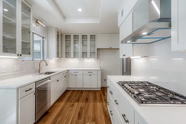 a kitchen with a sink stove and cabinets