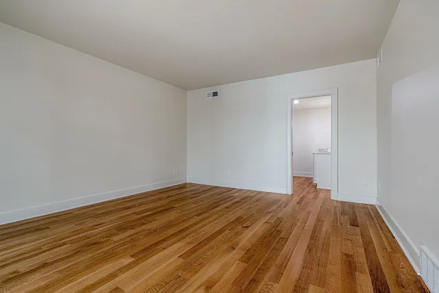 a view of a room with wooden floor and bathroom