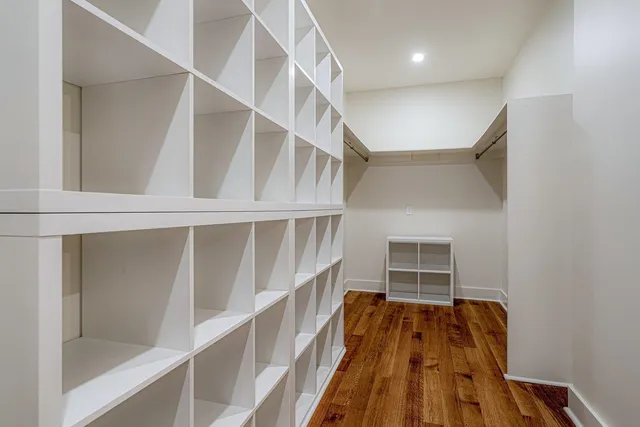 a view of walk in closet with empty racks