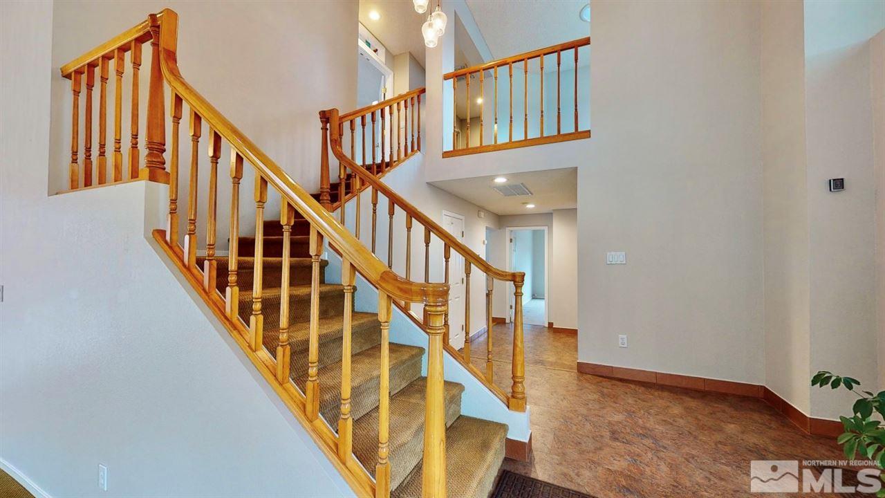 5380 Simons Drive Reno, NV 89523 - Photo 5 of 34 a view of staircase with lots of frames on wall and wooden floor