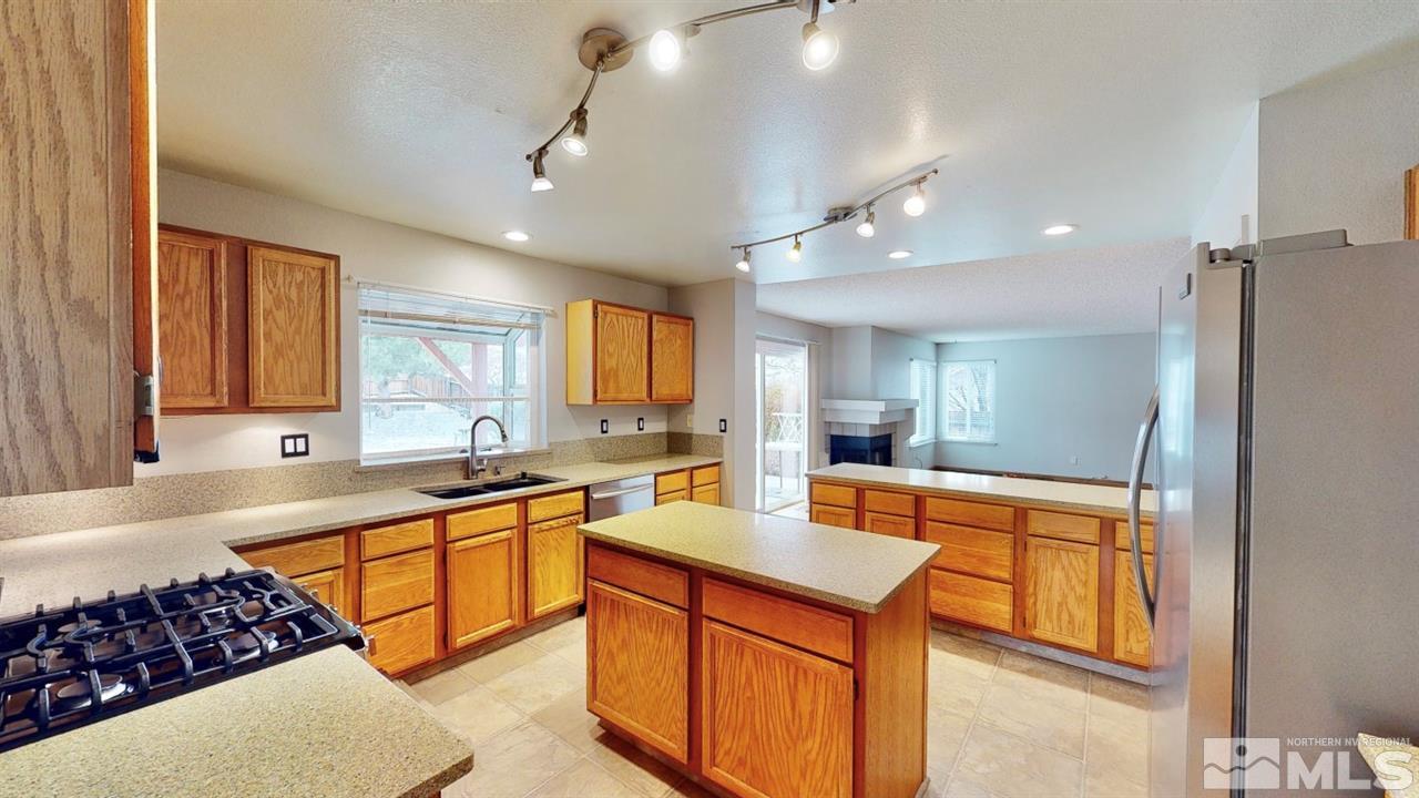 5380 Simons Drive Reno, NV 89523 - Photo 7 of 34 a large kitchen with stainless steel appliances granite countertop a sink stove and refrigerator