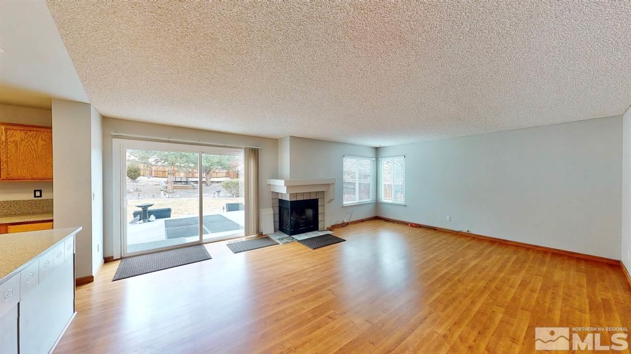 5380 Simons Drive Reno, NV 89523 - Photo 8 of 34 wooden floor fireplace and windows in an empty room