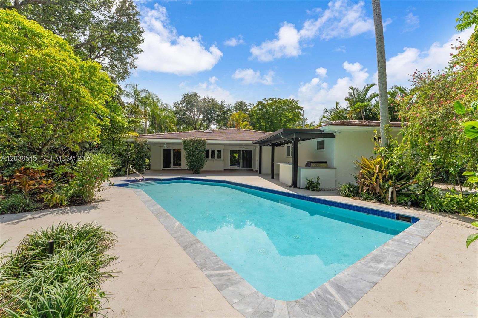 7711 Erwin Road Coral Gables, FL 33143 - Photo 24 of 26 a front view of house with yard and swimming pool