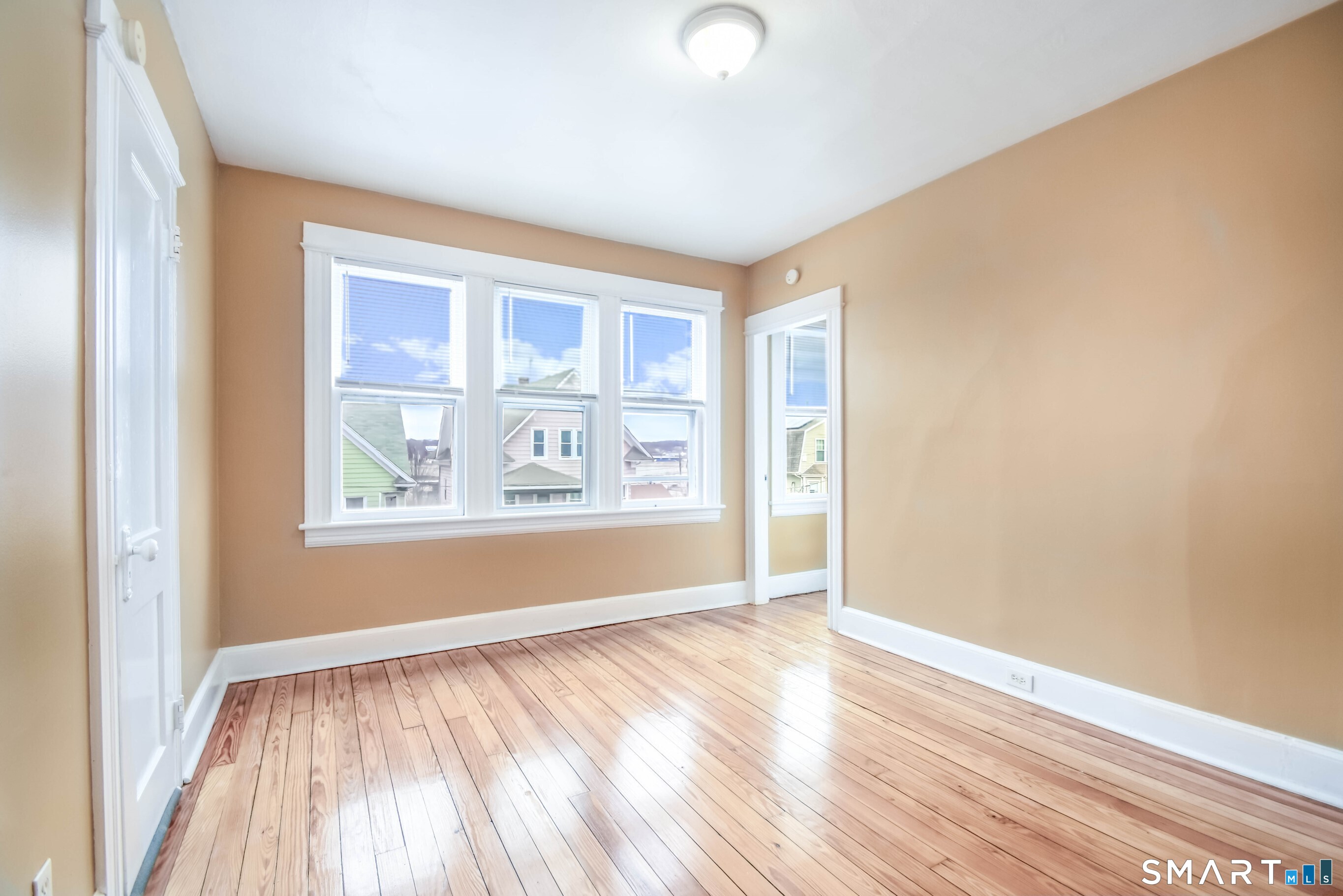 201 French Street Bridgeport, CT 06606 - Photo 5 of 30 an empty room with wooden floor and windows