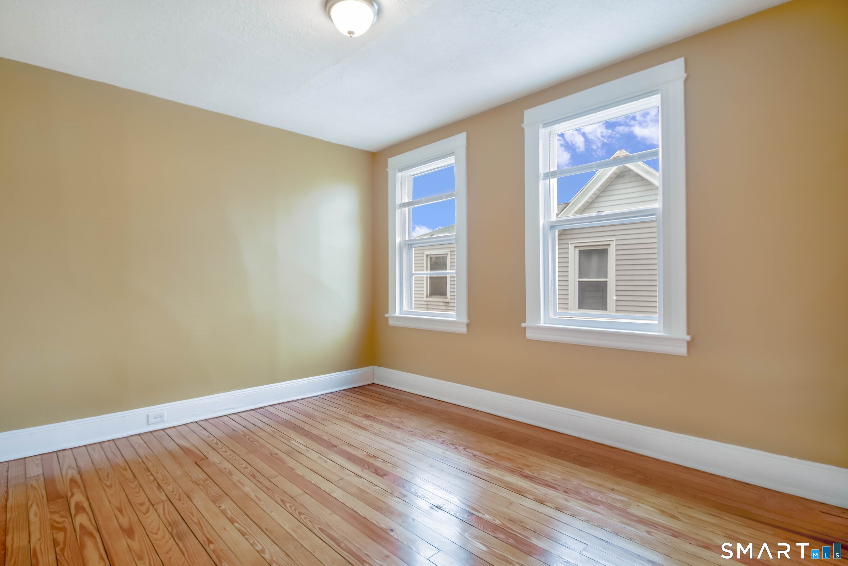 201 French Street Bridgeport, CT 06606 - Photo 6 of 30 a view of an empty room with wooden floor and a window
