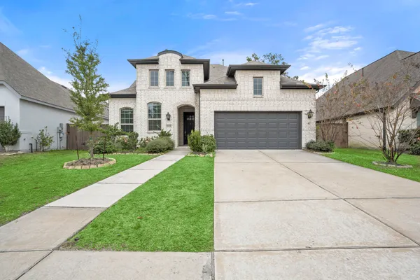 a front view of house with yard and green space