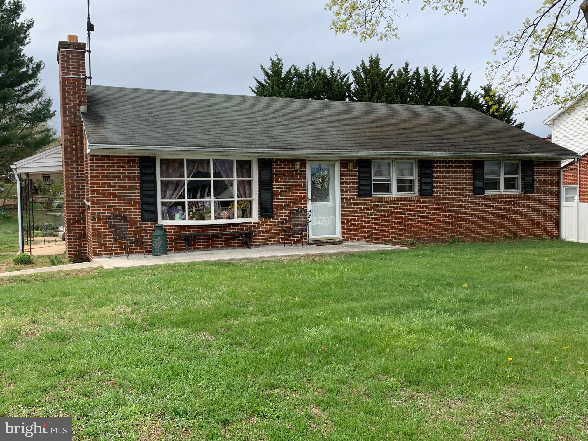 a front view of house with yard and green space