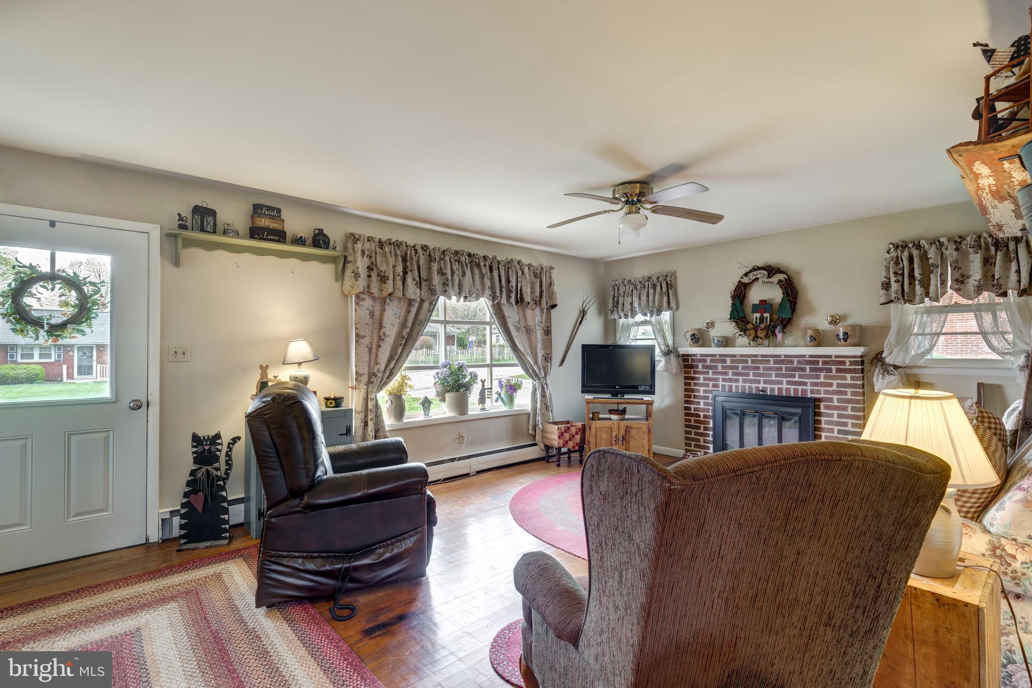 804 William Avenue Westminster, MD 21157 - Photo 4 of 20 a living room with furniture a chandelier and a fireplace