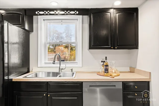 a kitchen with a sink a refrigerator and window