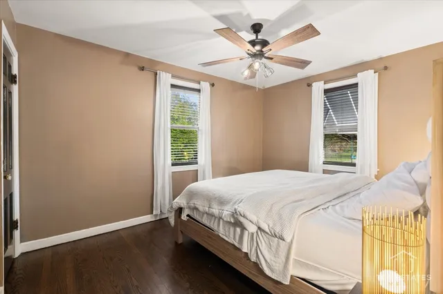 a bedroom with a large bed and a chandelier