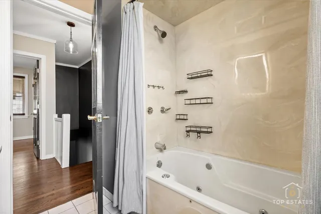 a bathroom with a bathtub and a shower