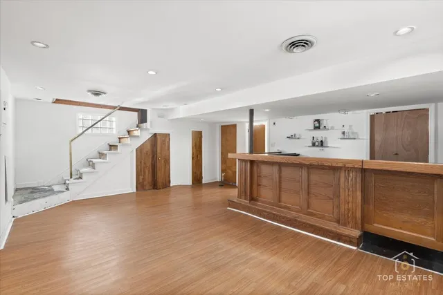 a big room with wooden floors and windows
