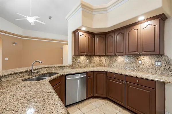 a kitchen with stainless steel appliances granite countertop a sink stove and cabinets