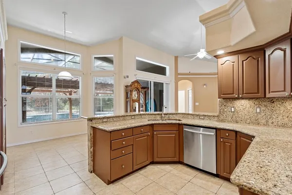 a kitchen with a sink stove and cabinets