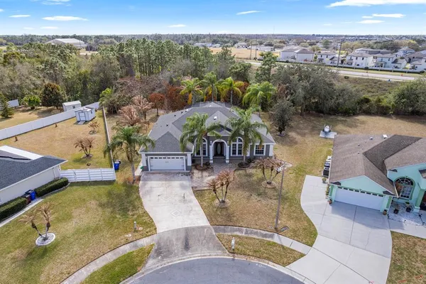 an aerial view of a house with garden space and ocean view